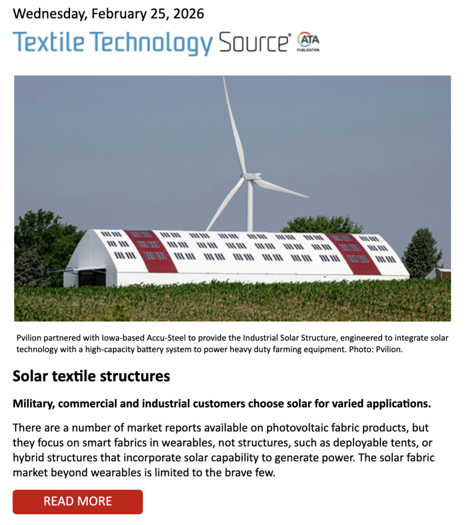 Wind turbine beside a modern, red-and-white solar structure in a green landscape, highlighting innovative textile technology applications.