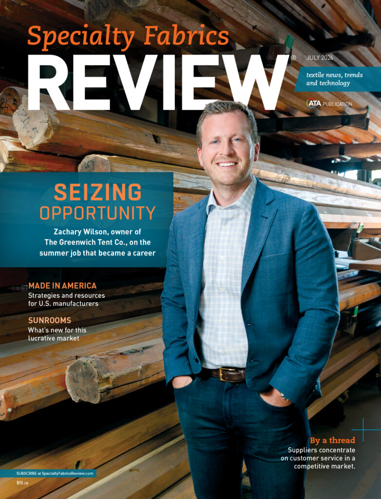 Man in a blue blazer smiles in front of wooden logs, with a magazine cover title and text about textiles and manufacturing trends.