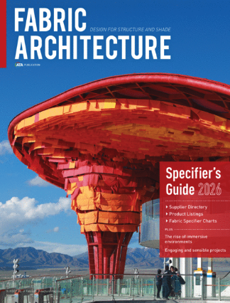 Colorful, layered fabric structure with a vibrant red and yellow design, set against a mountainous backdrop, showcasing architectural innovation.